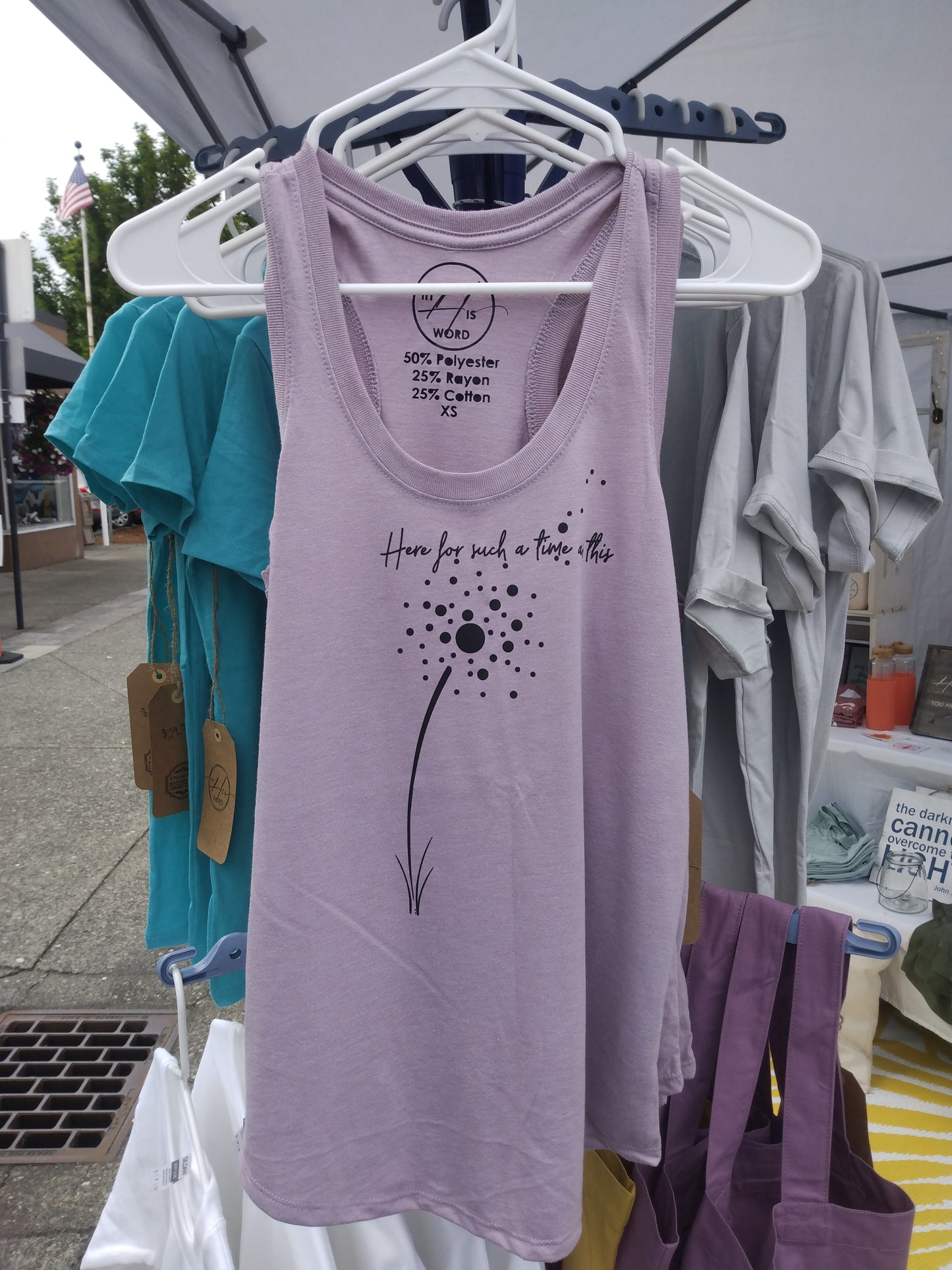 Heather Lavender, slightly fitted racerback tank top with curved hem. Abstract dandelion with Esther 4:14 reminder: "Here for such a time as this."