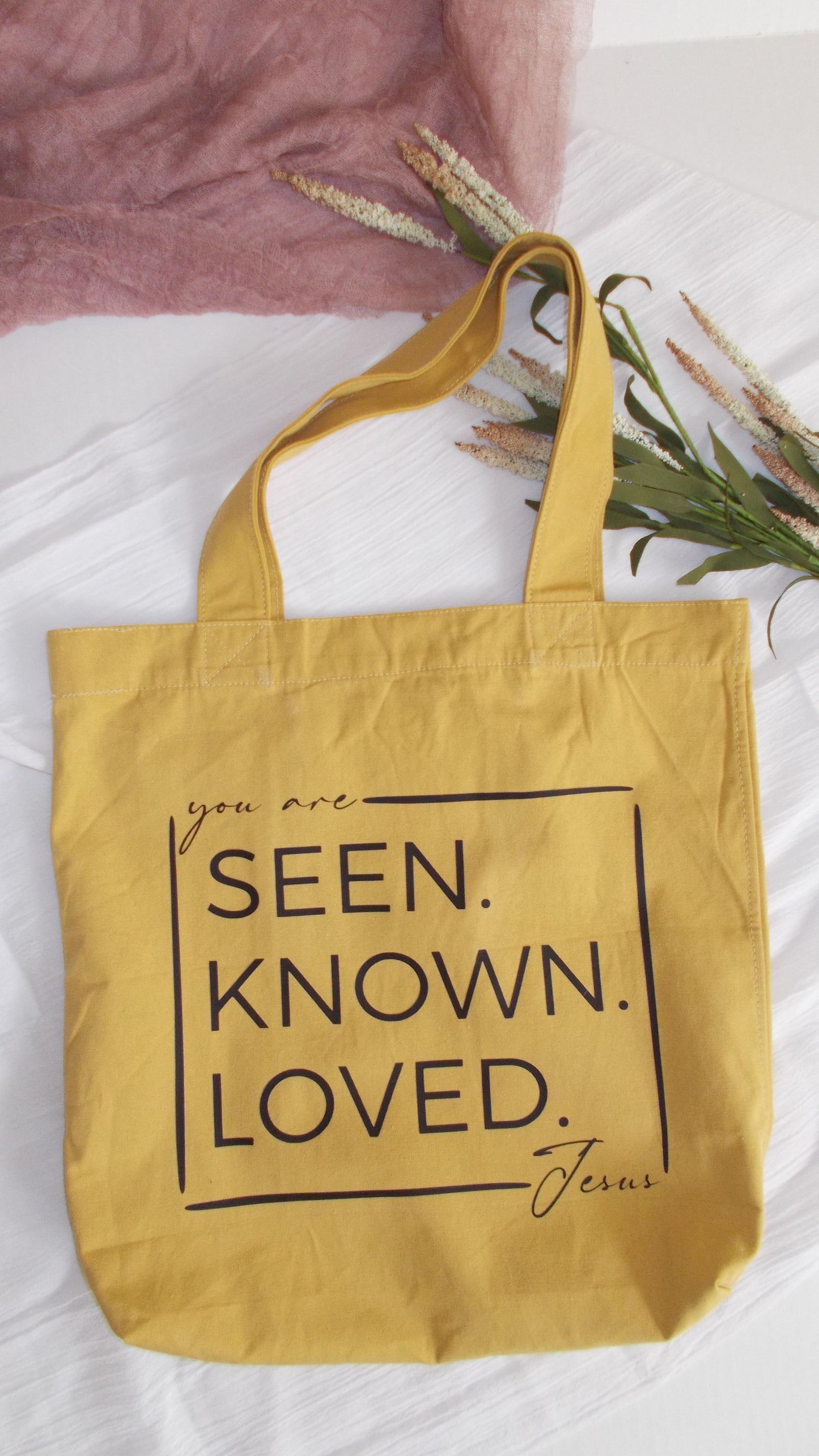 "You are Seen. Known. Loved. - Jesus." No matter what the day brings, you can carry around this message on a fashionable Mustard colored tote.